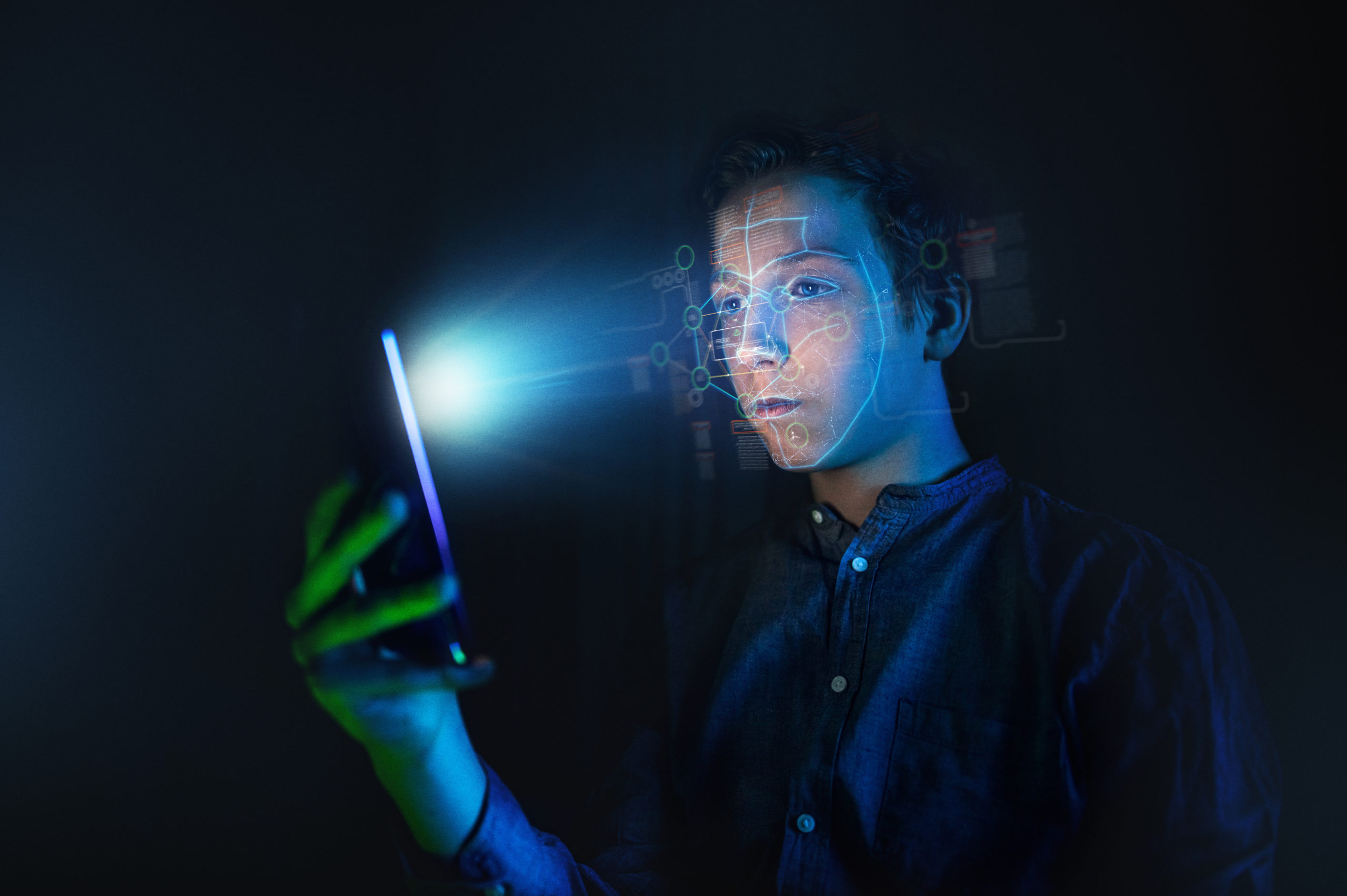 Featured Image. A teenager scanning his face with on a digital phone
