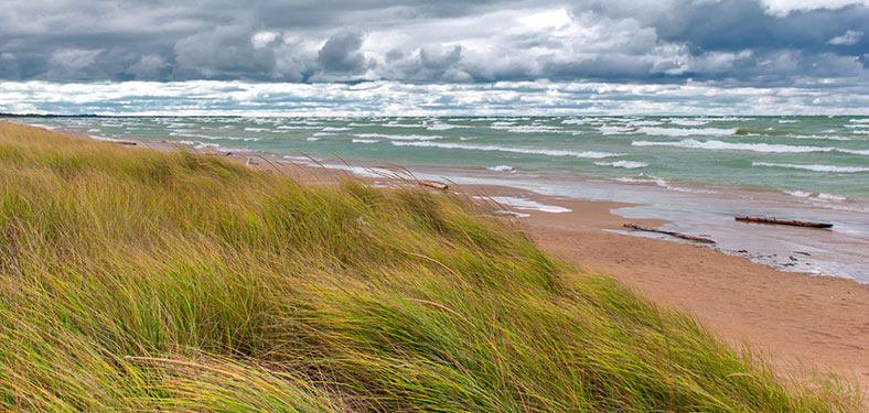 Featured Image. Storm clouds and sand dunes along Lake Huron