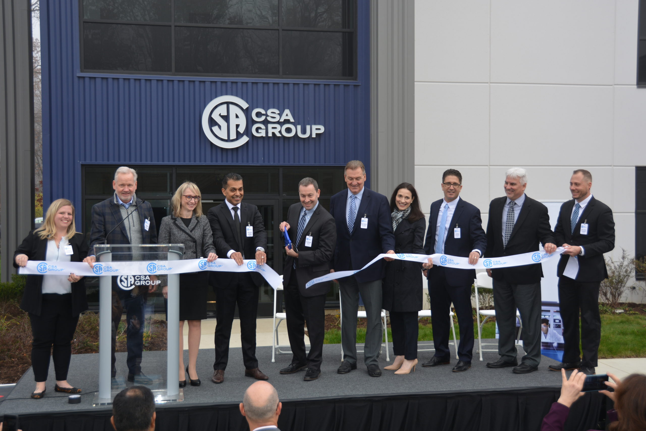 Featured Image. CSA Group Executive Team cutting the ribbon at the openning of the new Cleveland lab.