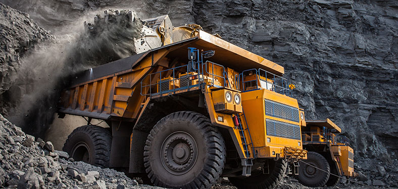Featured Image. A heavy truck carrying the rocks from a mining site