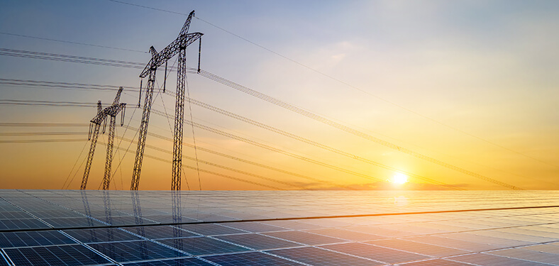 Featured Image. High voltage pylons with electric power lines transferring electricity