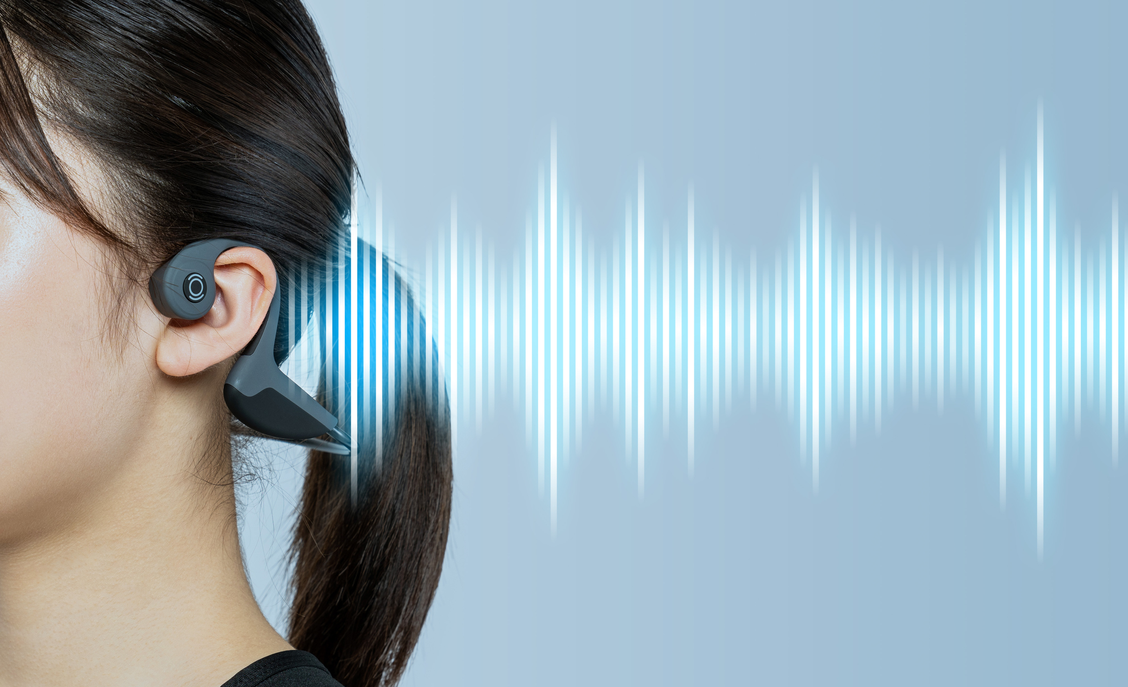Featured Image. Young woman wearing a bone conduction headphones.